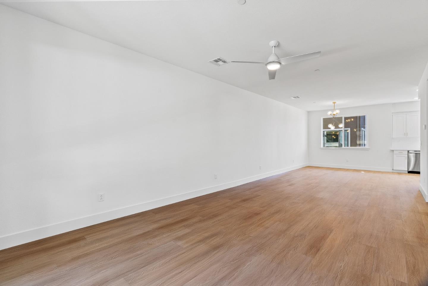 947 Woodside Road Redwood City, CA 94061 - Photo 6 of 51 an empty room with wooden floor and windows