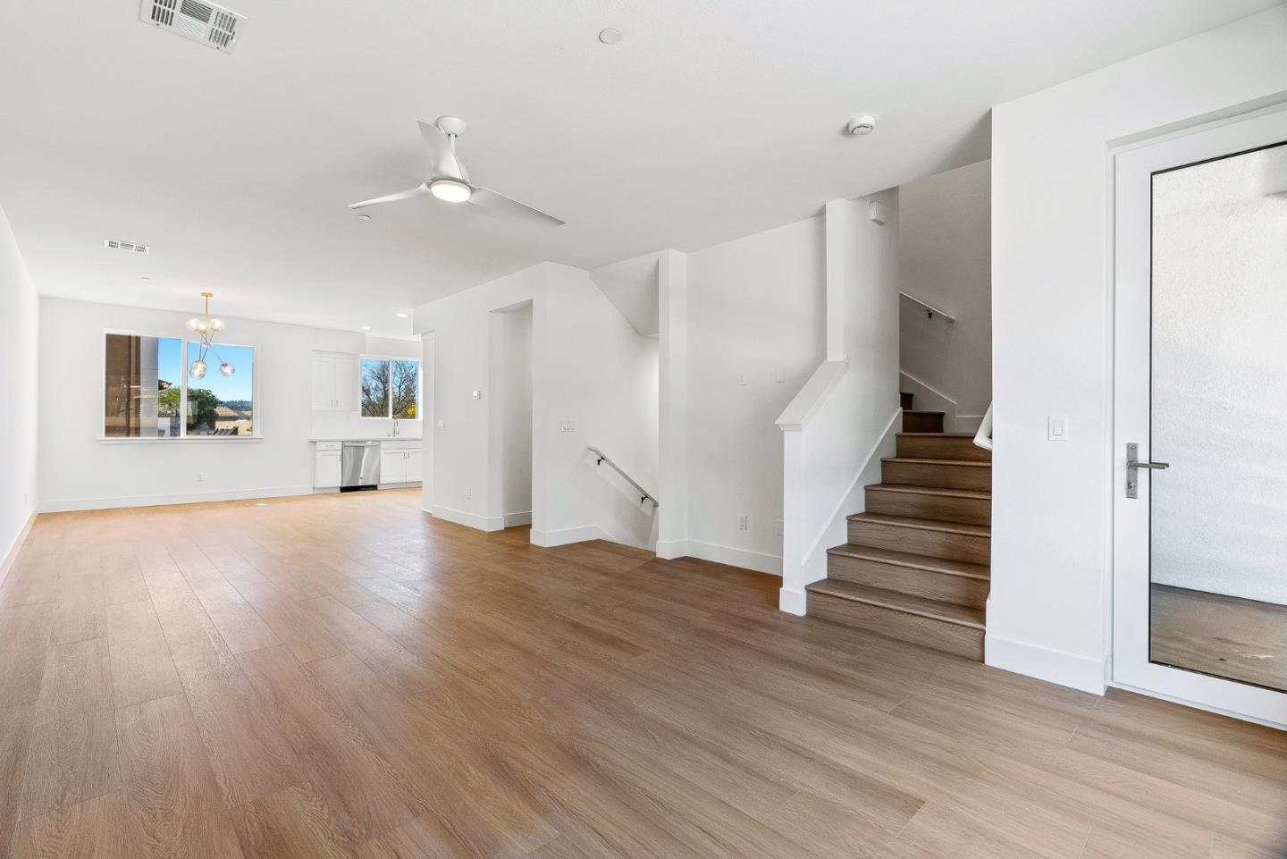 947 Woodside Road Redwood City, CA 94061 - Photo 8 of 51 a view of an empty room with wooden floor and stairs