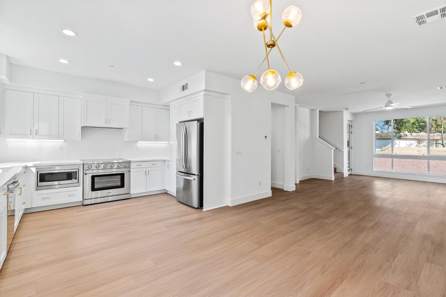 947 Woodside Road Redwood City, CA 94061 - Photo 9 of 51 a view of a kitchen with a stove cabinets and wooden floor