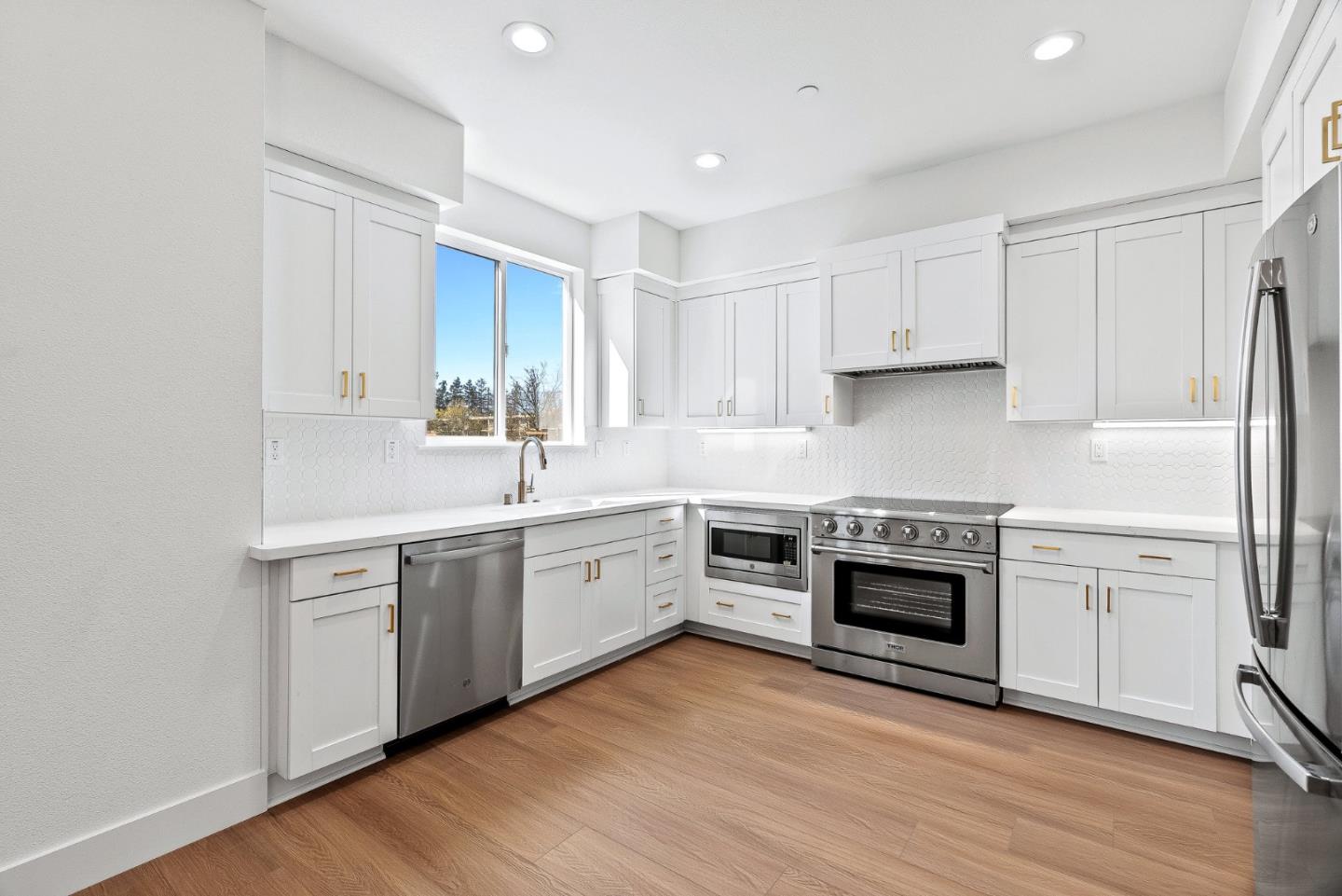 947 Woodside Road Redwood City, CA 94061 - Photo 10 of 51 a kitchen with stainless steel appliances granite countertop a sink a stove a refrigerator and a microwave