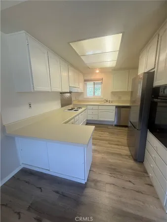 a view of a building with a big yard and large trees