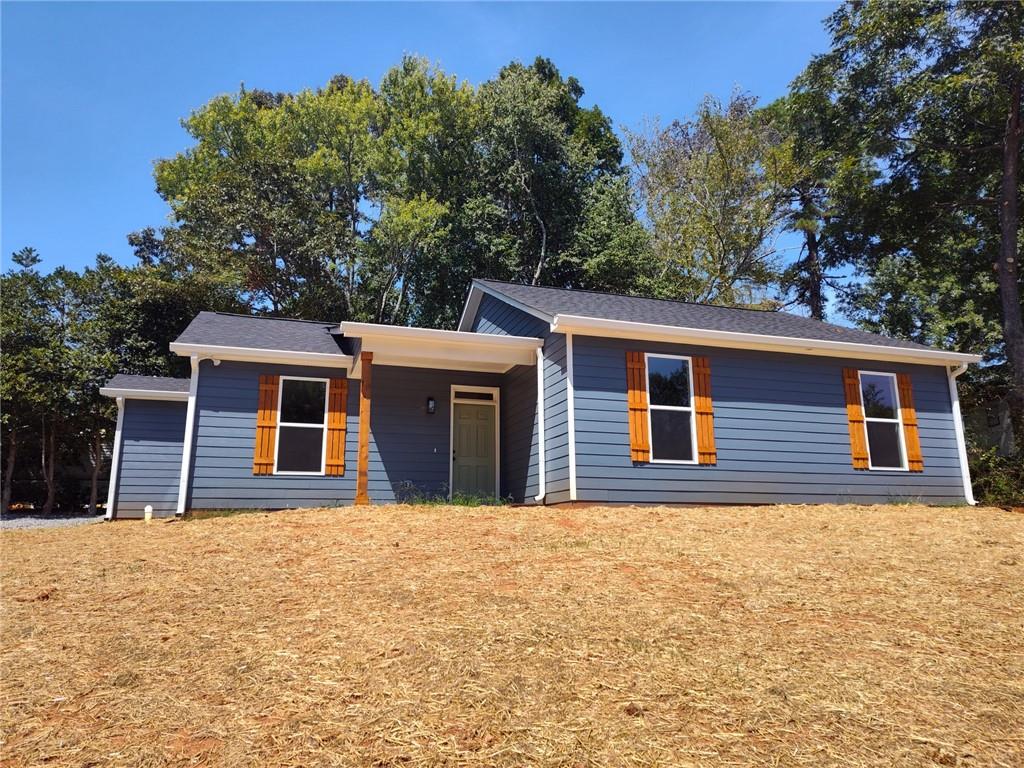 5020 Chris Road Cumming, GA 30041 - Photo 1 of 1 a house with trees in the background
