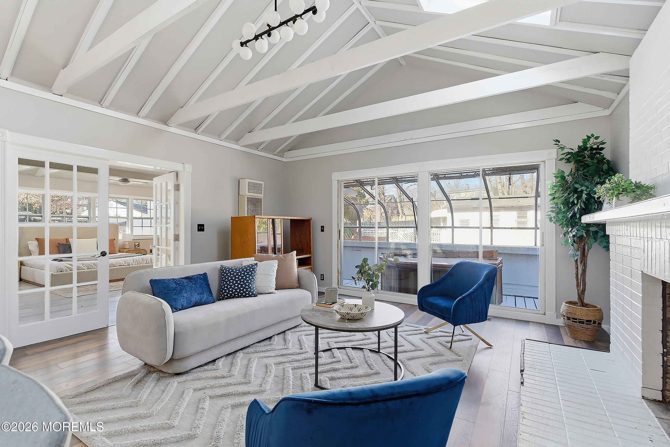 215 Sunset Lane Howell, NJ 07731 - Photo 14 of 27 a living room with furniture a fireplace and a potted plant