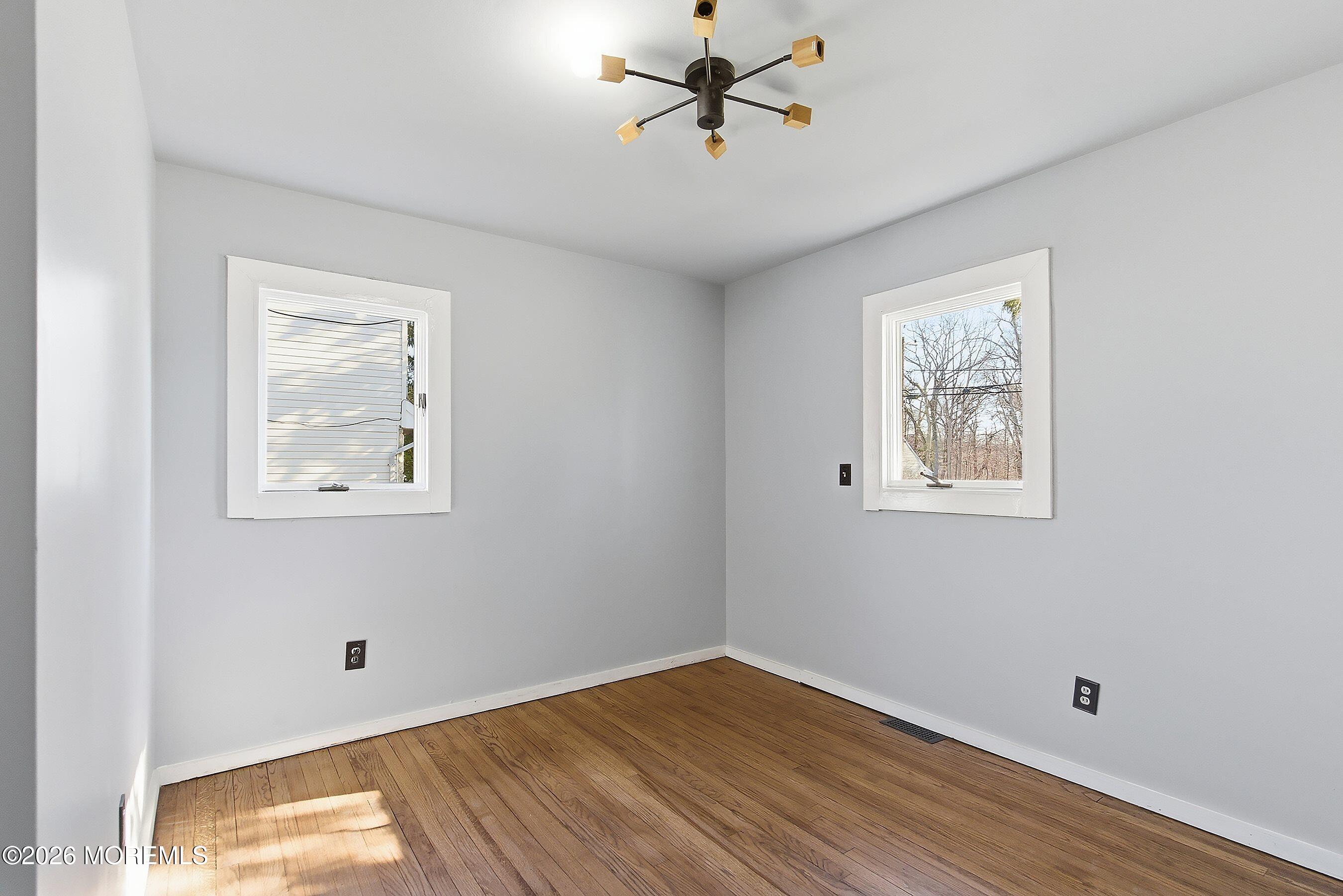 215 Sunset Lane Howell, NJ 07731 - Photo 17 of 27 a view of empty room with wooden floor