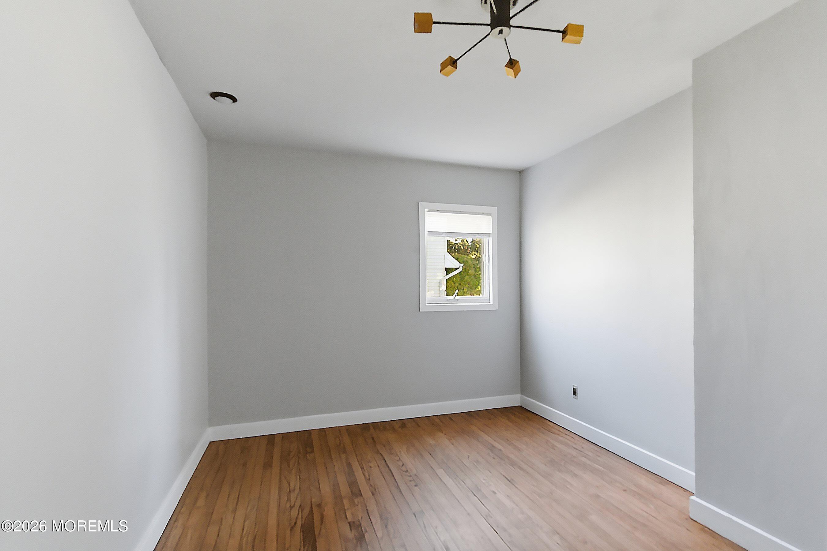 215 Sunset Lane Howell, NJ 07731 - Photo 18 of 27 a view of room with hardwood floor and window