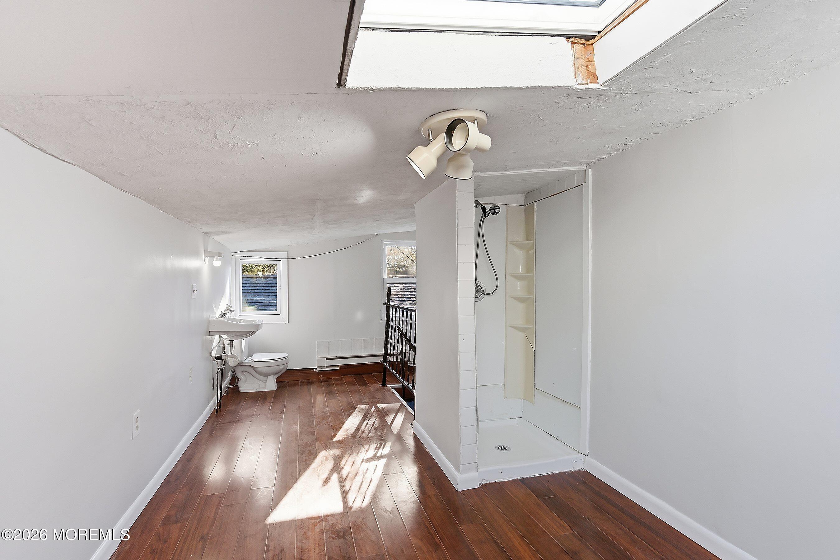 215 Sunset Lane Howell, NJ 07731 - Photo 22 of 27 wooden floor in an empty room with a window