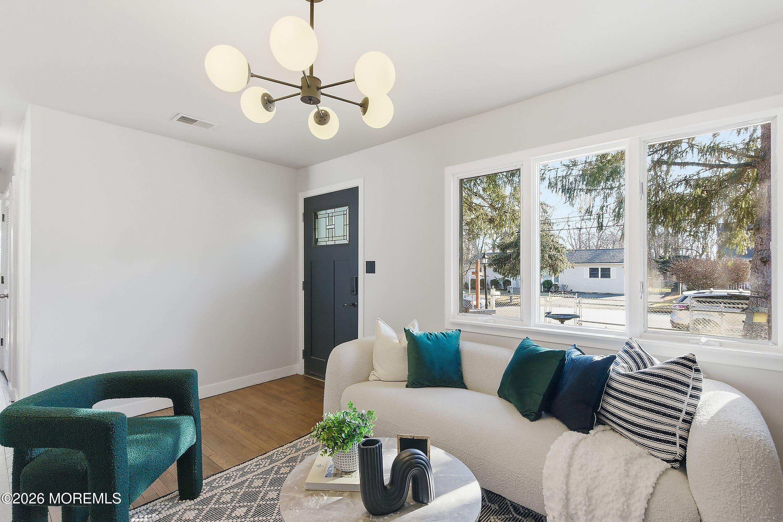 215 Sunset Lane Howell, NJ 07731 - Photo 6 of 27 a living room with furniture and a large window