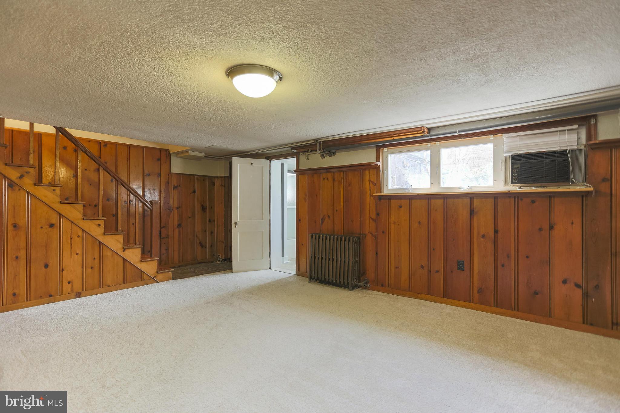 403 Overbrook Road Catonsville, MD 21228 - Photo 23 of 30 a view of an empty room with wooden floor and stairs