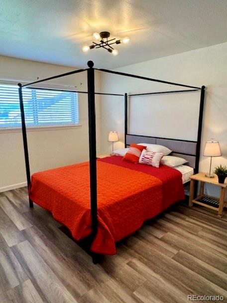 120 Norgren Road, Unit A B C Fraser, CO 80442 - Photo 13 of 39 a bedroom with a bed and wooden floor