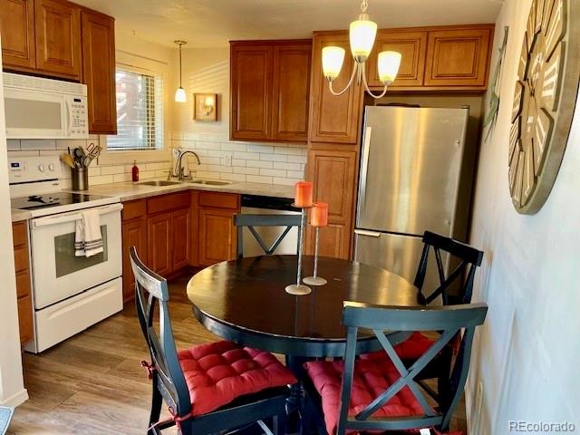 120 Norgren Road, Unit A B C Fraser, CO 80442 - Photo 21 of 39 a kitchen with stainless steel appliances granite countertop a dining table chairs refrigerator and sink