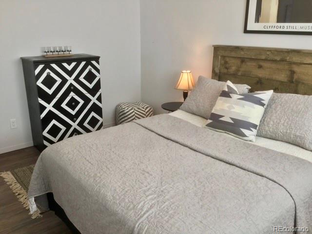 120 Norgren Road, Unit A B C Fraser, CO 80442 - Photo 25 of 39 a bedroom with a bed and a painting on the wall