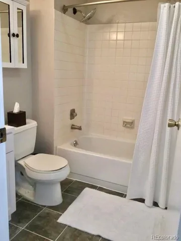 a living room with furniture and a lamp