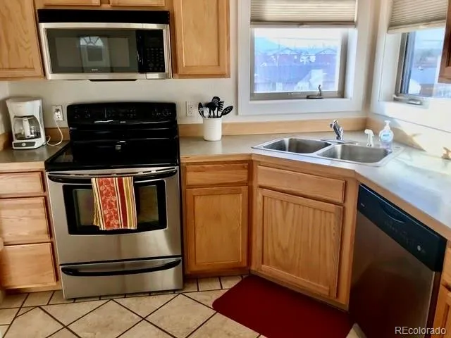 a kitchen with a sink cabinets and window