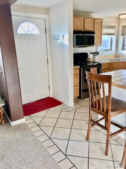 120 Norgren Road, Unit A B C Fraser, CO 80442 - Photo 35 of 39 a kitchen with stainless steel appliances kitchen island granite countertop a refrigerator and a stove top oven