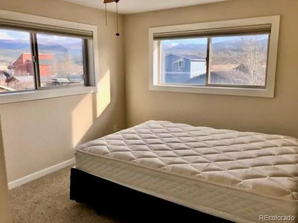 a bed sitting in a bedroom next to a window