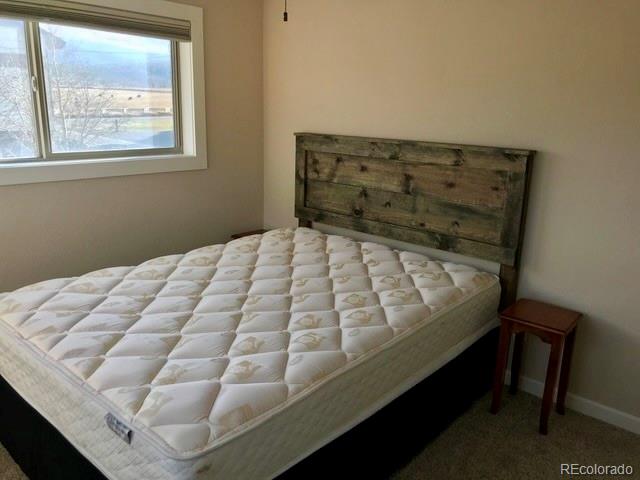 120 Norgren Road, Unit A B C Fraser, CO 80442 - Photo 37 of 39 a bed sitting in a bedroom next to a window