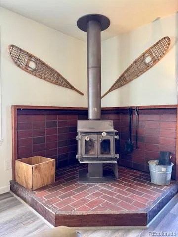 a kitchen with stainless steel appliances granite countertop a dining table chairs and a refrigerator