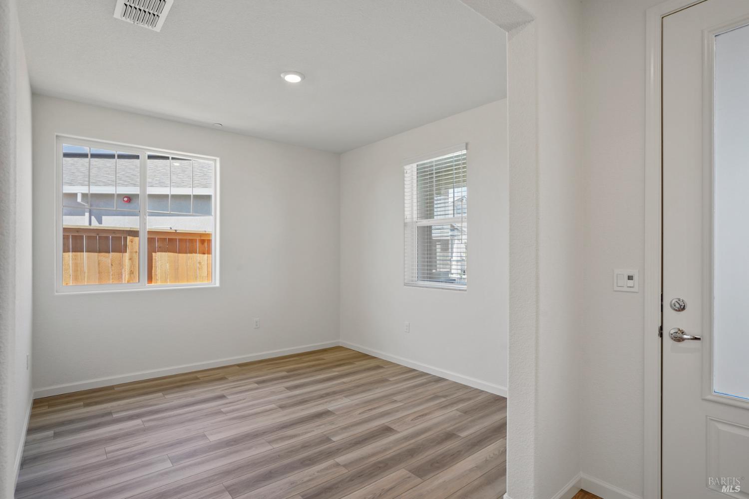 2240 Front Porch Lane Rio Vista, CA 94571 - Photo 3 of 16 a view of an empty room with wooden floor and a window