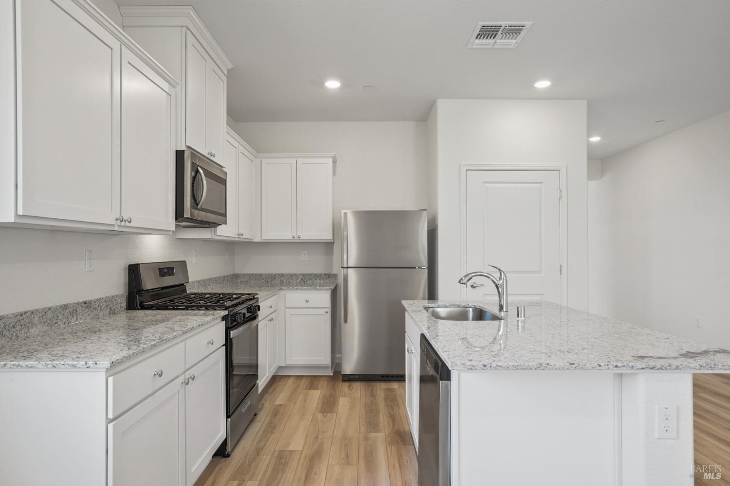 2240 Front Porch Lane Rio Vista, CA 94571 - Photo 6 of 16 a kitchen with a sink a stove a refrigerator and cabinets