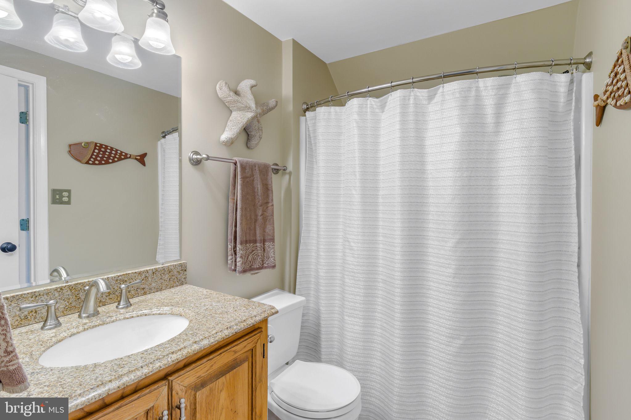166 Nottingham Drive Reedville, VA 22539 - Photo 16 of 61 a bathroom with a granite countertop sink and a mirror