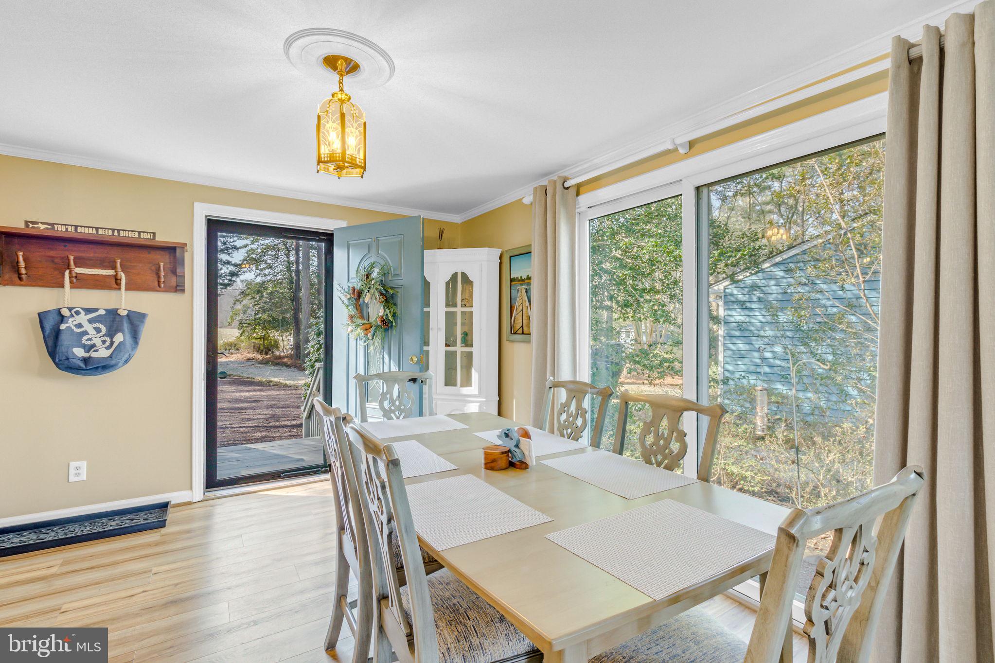 166 Nottingham Drive Reedville, VA 22539 - Photo 19 of 61 a view of a dining room with furniture window and outside view