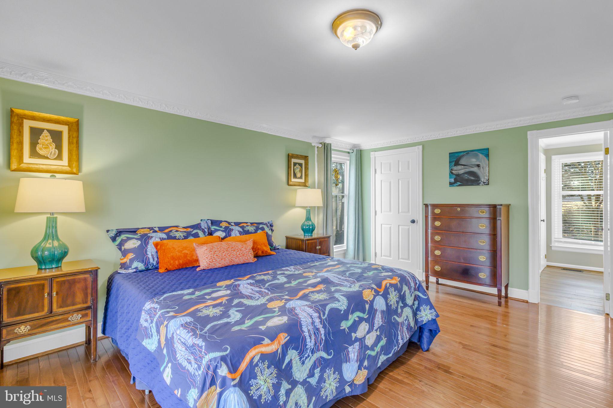 166 Nottingham Drive Reedville, VA 22539 - Photo 28 of 61 a bedroom with a bed and wooden floor