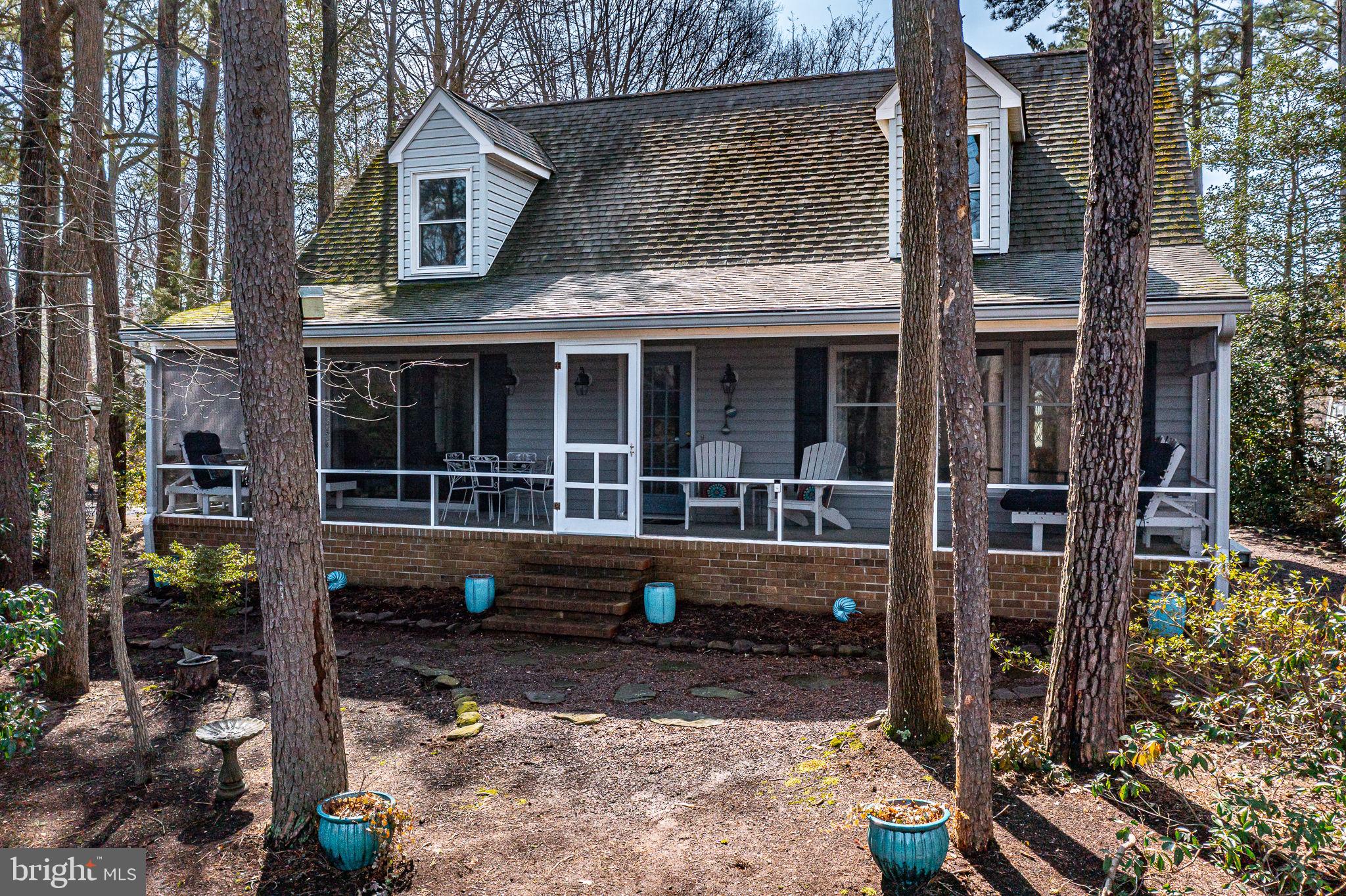 166 Nottingham Drive Reedville, VA 22539 - Photo 36 of 61 a front view of a house with glass windows and a tree