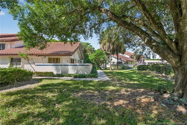 a house with green field in front of it