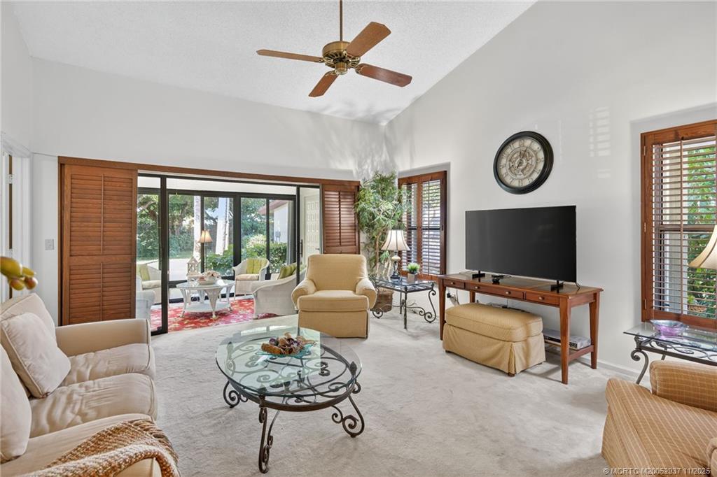 6001 Southeast Martinique Drive, Unit 104 Stuart, FL 34997 - Photo 11 of 36 a living room with furniture and a flat screen tv