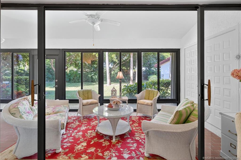 6001 Southeast Martinique Drive, Unit 104 Stuart, FL 34997 - Photo 14 of 36 a living room with furniture and a large window