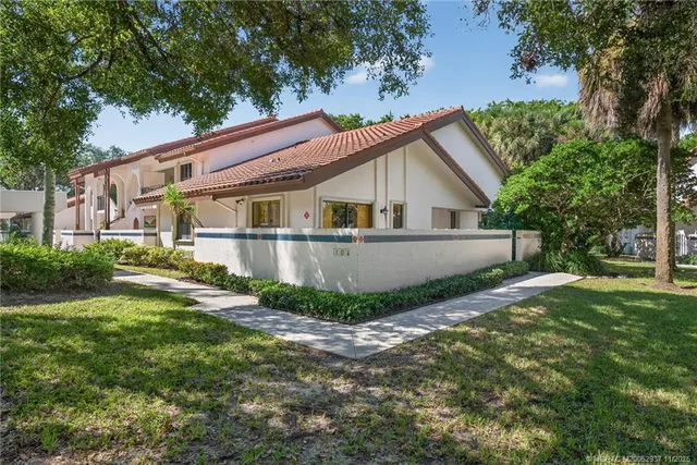 a view of a house with a yard and sitting area