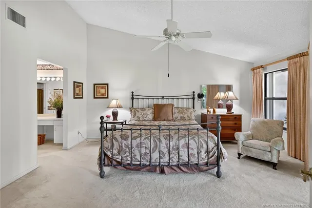 a bedroom with a bed a couch and dresser