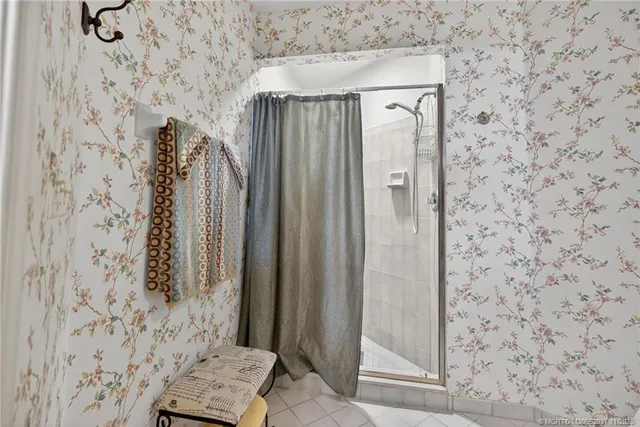 a bathroom with a shower and a sink