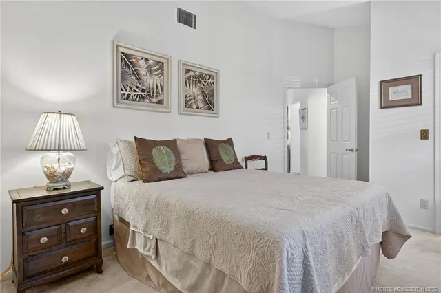 a bedroom with a bed and a lamp on table