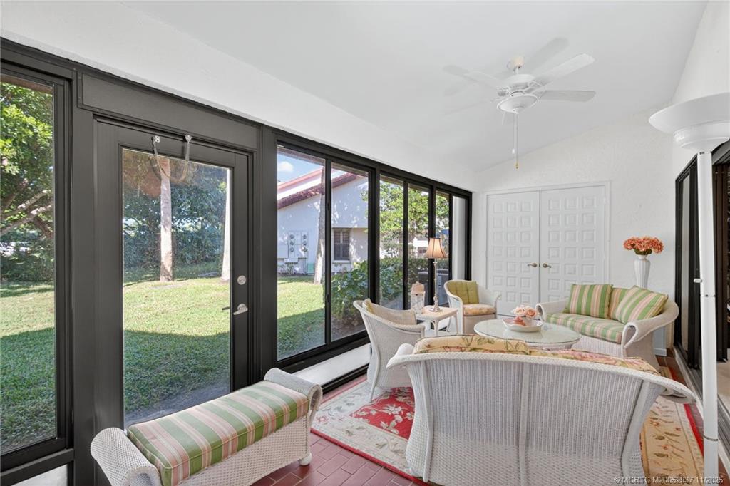 6001 Southeast Martinique Drive, Unit 104 Stuart, FL 34997 - Photo 30 of 36 a living room with furniture and a large window