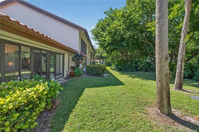 a view of a house with a backyard and a patio