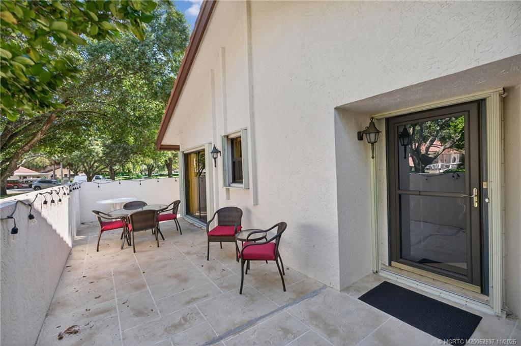 6001 Southeast Martinique Drive, Unit 104 Stuart, FL 34997 - Photo 6 of 36 a view of two chairs in the balcony