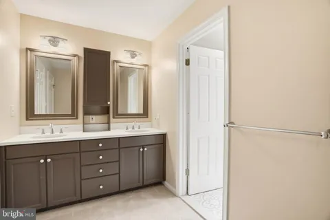 a bathroom with a double vanity sink and mirror