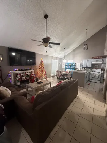 a living room with lots of furniture and kitchen view