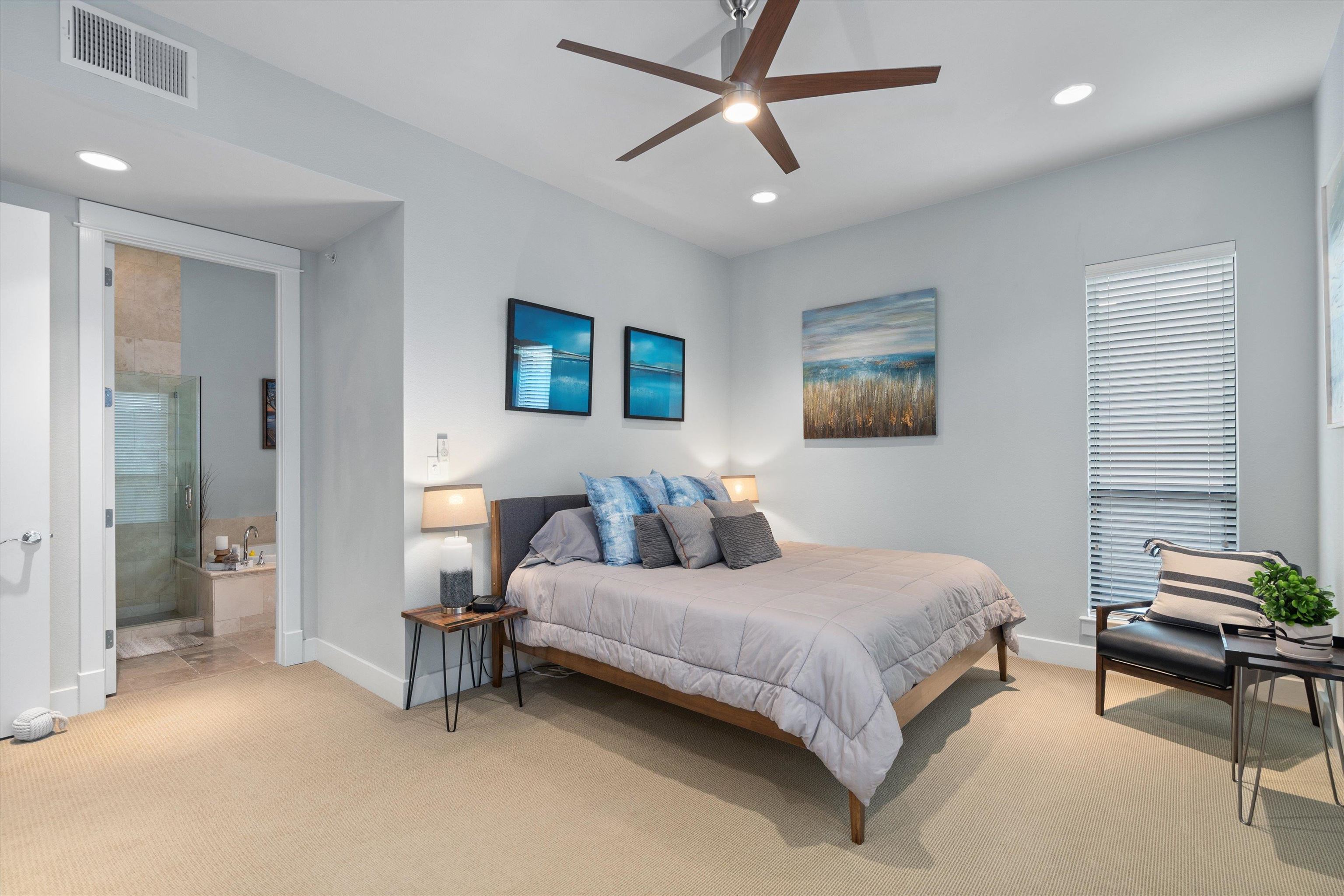 1101 Ivean Pearson Road Lago Vista, TX 78645 - Photo 13 of 30 a bedroom with a bed and a chandelier