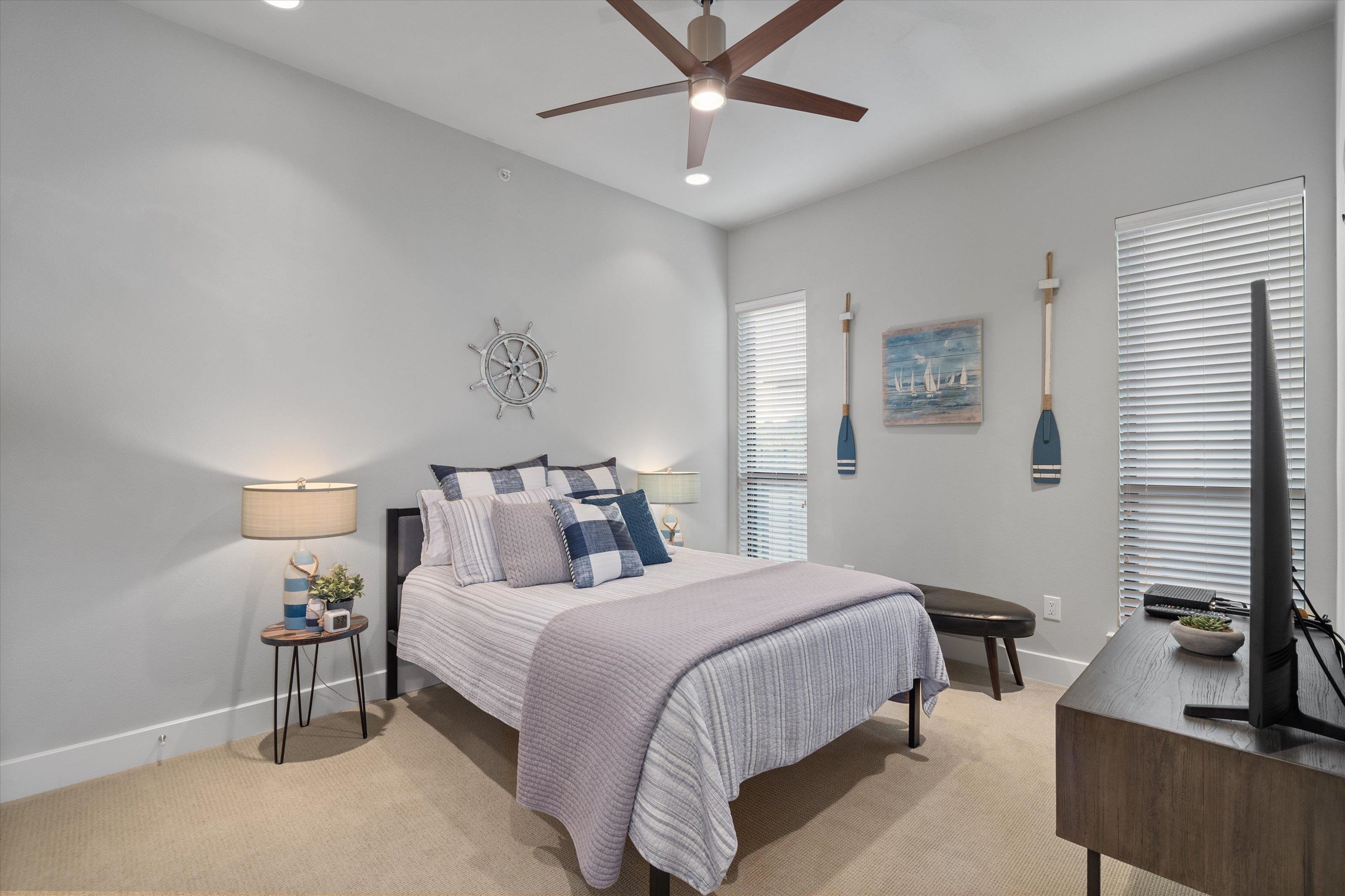 1101 Ivean Pearson Road Lago Vista, TX 78645 - Photo 17 of 30 a bedroom with a bed and a chandelier