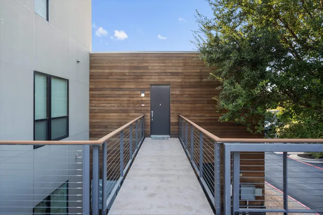 a view of balcony with wooden floor and fence