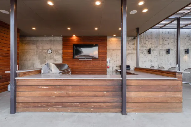 a bathroom with a sink a large mirror and shower