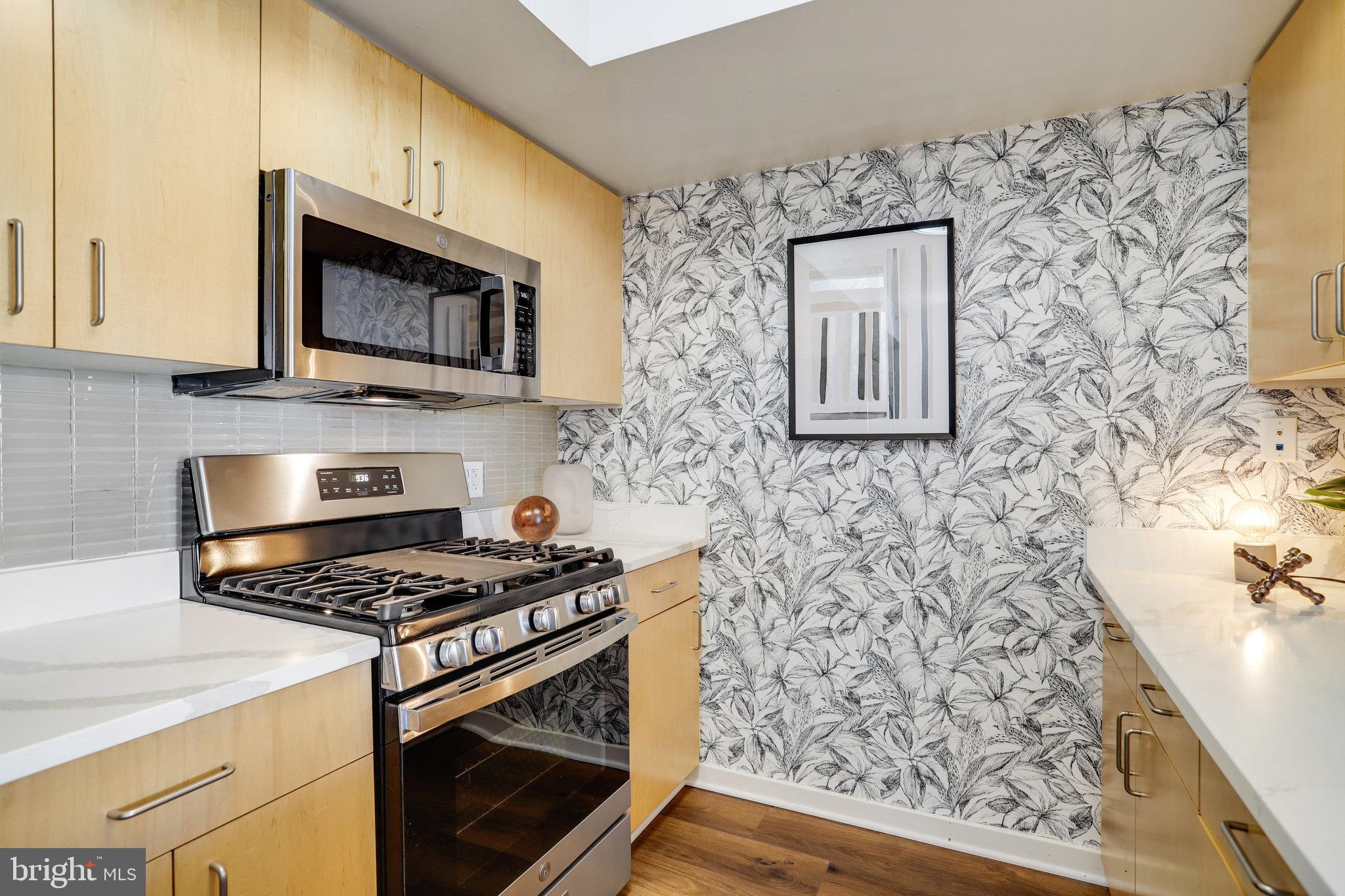1000 New Jersey Avenue Southeast, Unit 914 Washington, DC 20003 - Photo 11 of 48 a kitchen with a stove and a microwave