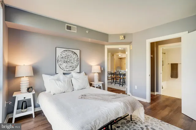 a bedroom with a large bed and a lamp