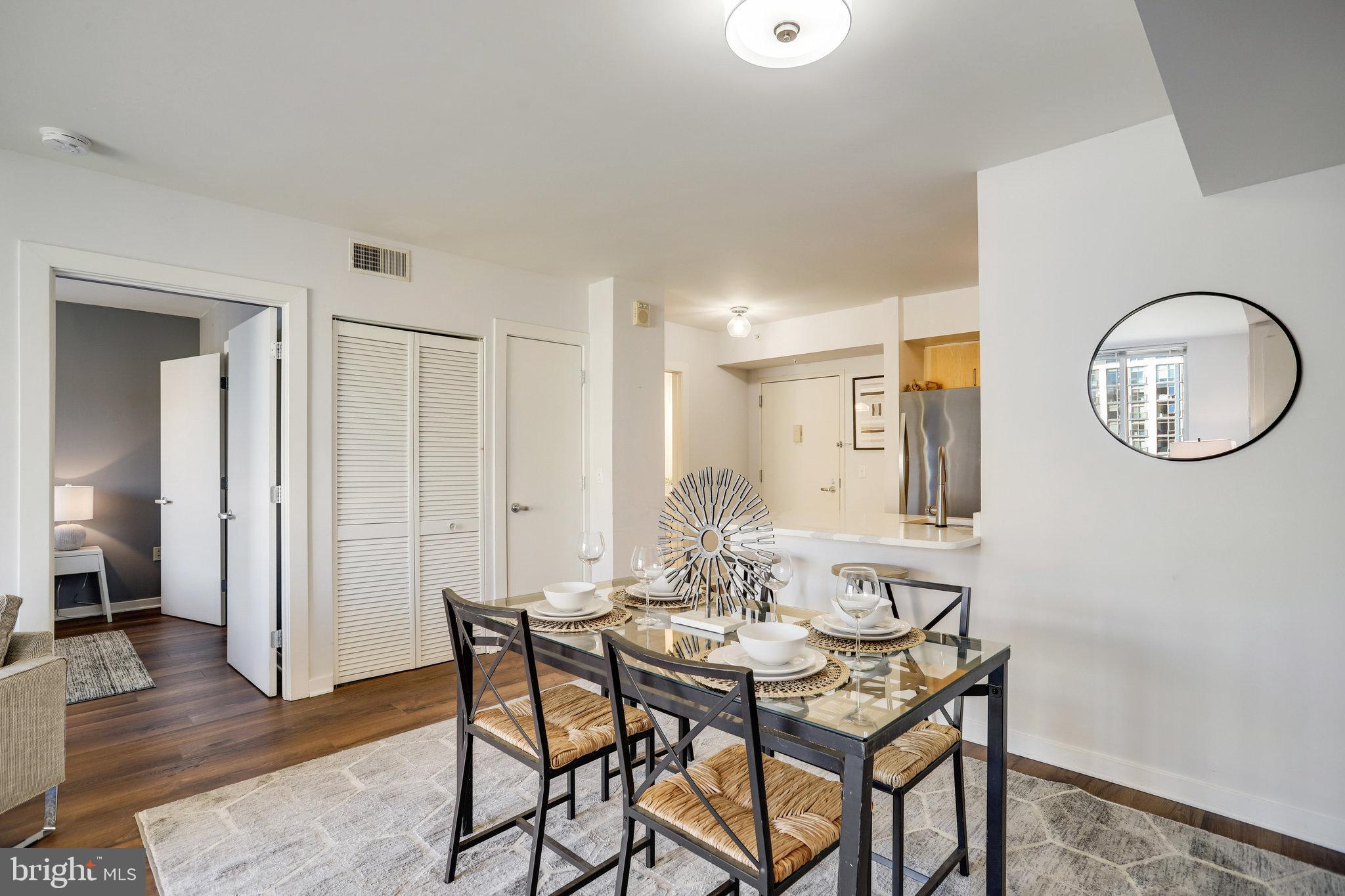 1000 New Jersey Avenue Southeast, Unit 914 Washington, DC 20003 - Photo 20 of 48 a view of a dining room with furniture and wooden floor