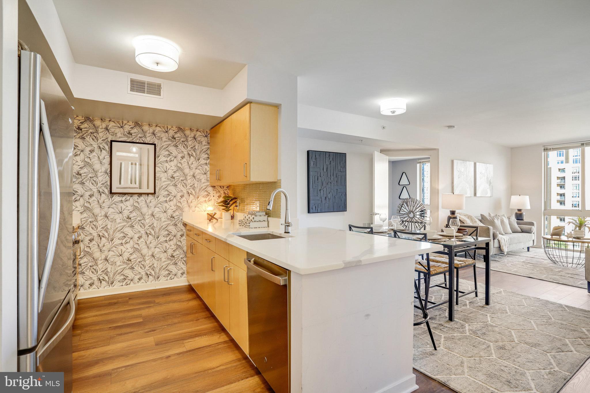 1000 New Jersey Avenue Southeast, Unit 914 Washington, DC 20003 - Photo 2 of 48 a large white kitchen with sink and cabinets