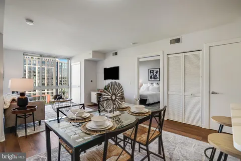 a view of a livingroom with furniture and a table in a room