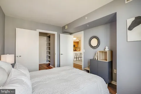 a bedroom with a bed and a chandelier