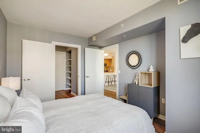 a bedroom with a bed and a chandelier